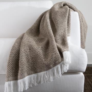 Sunbrella Herringbone Indoor Outdoor Throw spice on couch