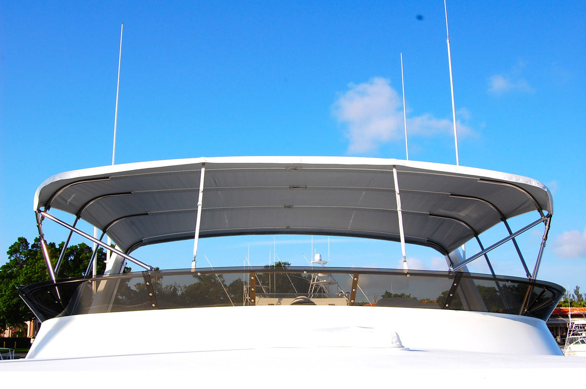 Light-colored bimini canvas supported above a motorboat cockpit