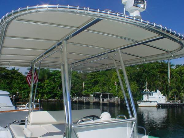 Light-colored T-top canvas laced around the frame above a center console
