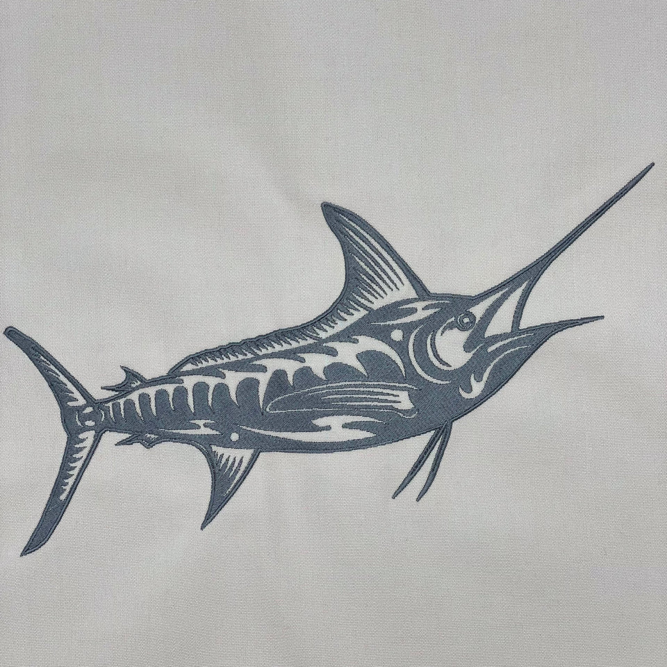 Dark marlin embroidery on a light-colored fabric panel