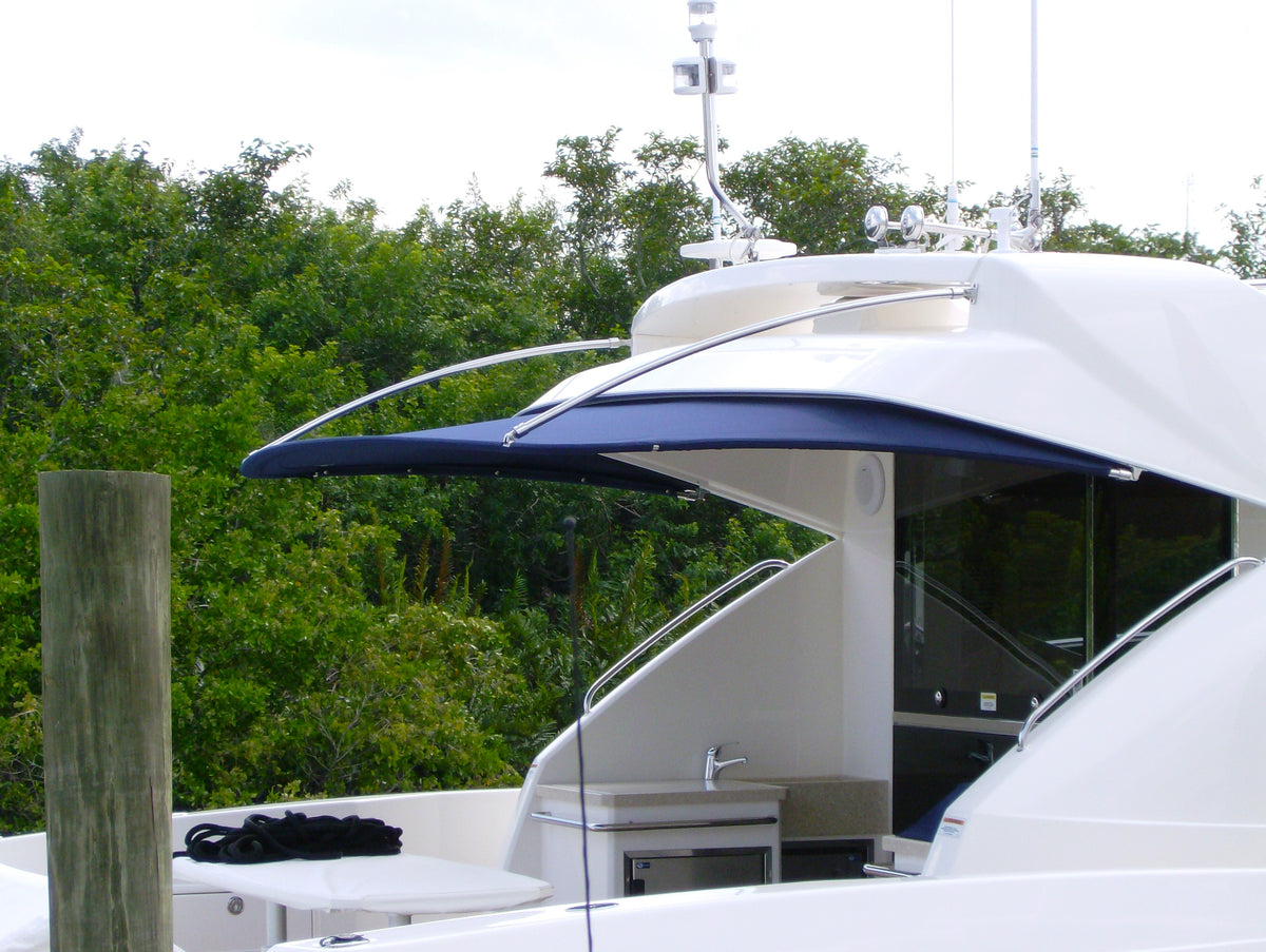 Blue aft brow shade extending behind the roof of a white yacht