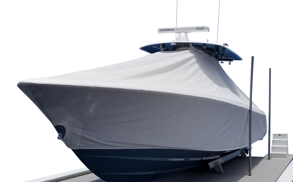 Gray custom boat cover fitted over a center console boat on a lift