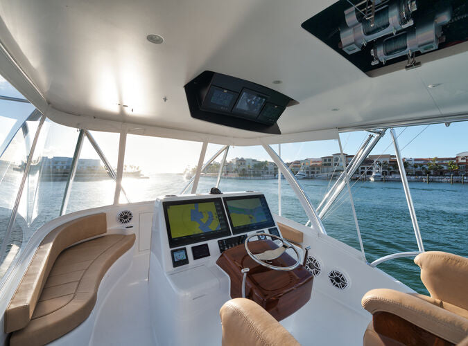 Viking 56 helm with tan seating, navigation displays, and clear enclosure panels
