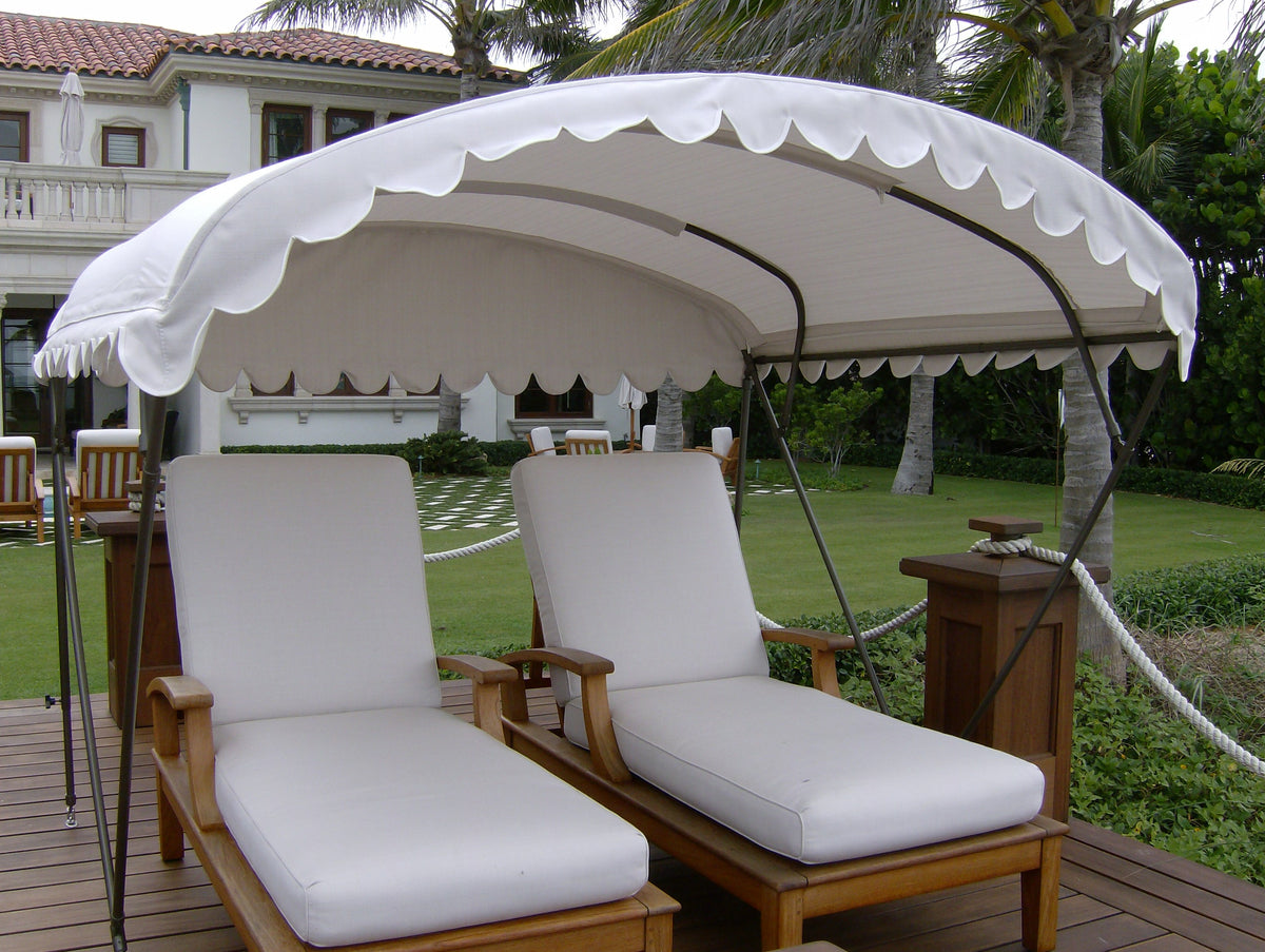 White freestanding dockside awning providing shade over two lounge chairs