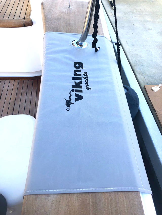 Light-colored custom boat step pad beside deck hardware