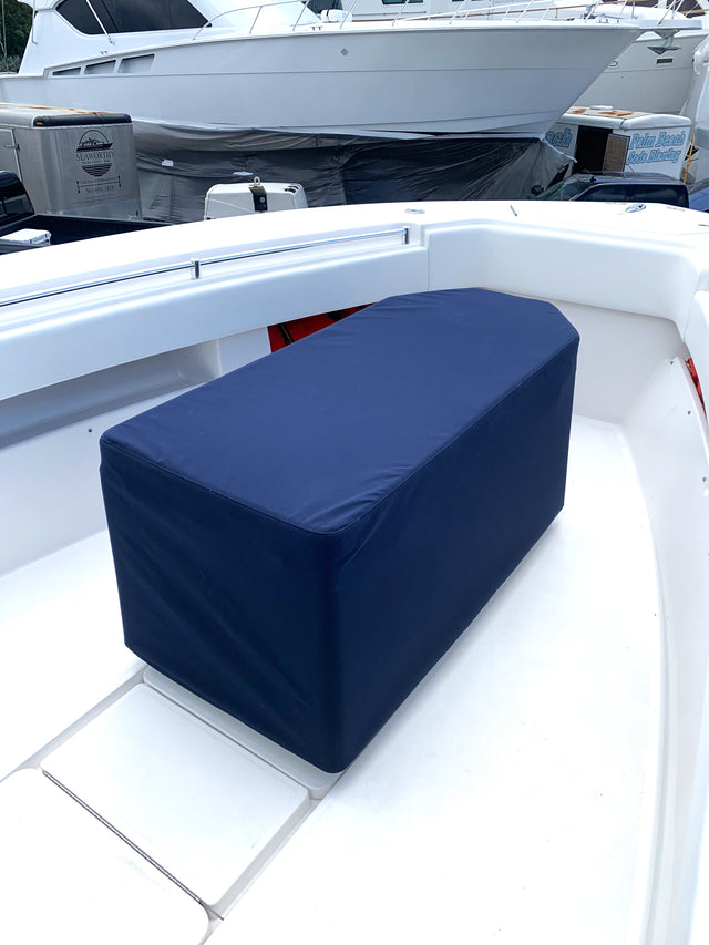 Navy fitted cover over a coffin-box storage compartment on a boat