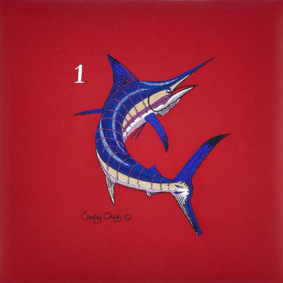Blue and white marlin embroidery by Carey Chen on a red background
