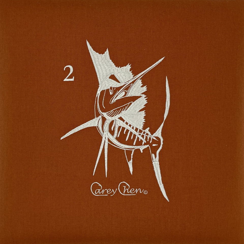 White marlin embroidery by Carey Chen on a warm brown background