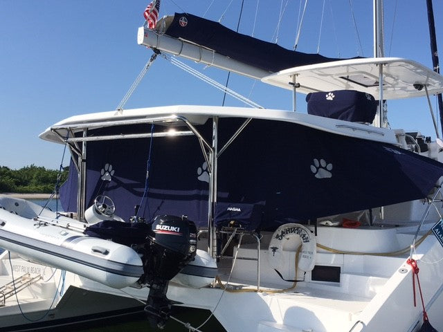 Dark blue weather curtain beneath a sailboat bimini