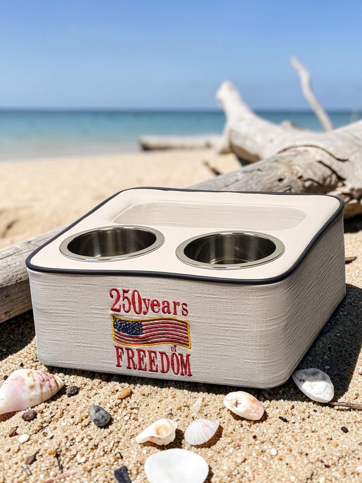 Marine drink caddy on teak boat deck with dock lines, Sunbrella Horizon White beach background
