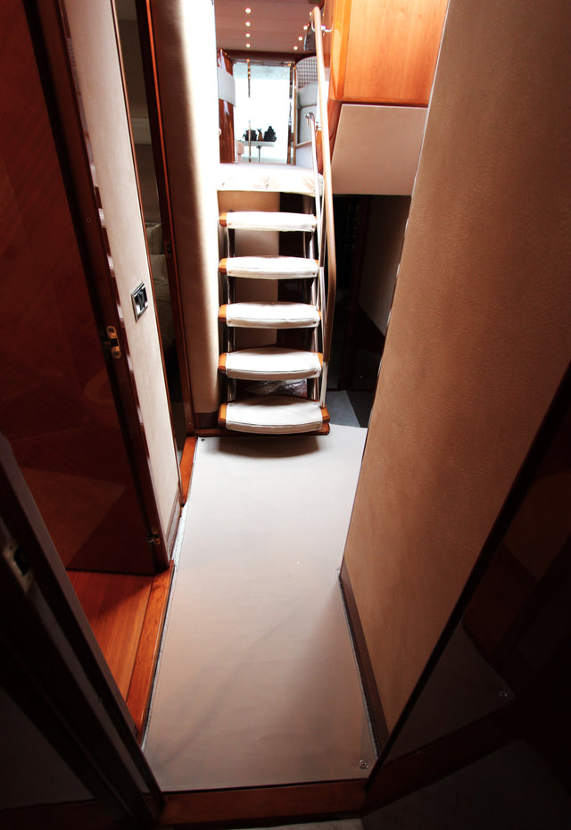 Light-colored carpet runner along a boat cabin walkway and steps