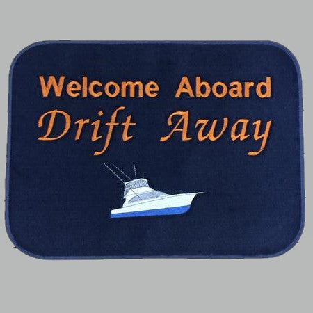 Navy Drift Away boarding mat with orange Welcome Aboard lettering and a white sportfish boat design